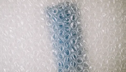 A soft, out-of-focus background featuring light blue and white bubbles, ideal for packaging and moving company text overlays.