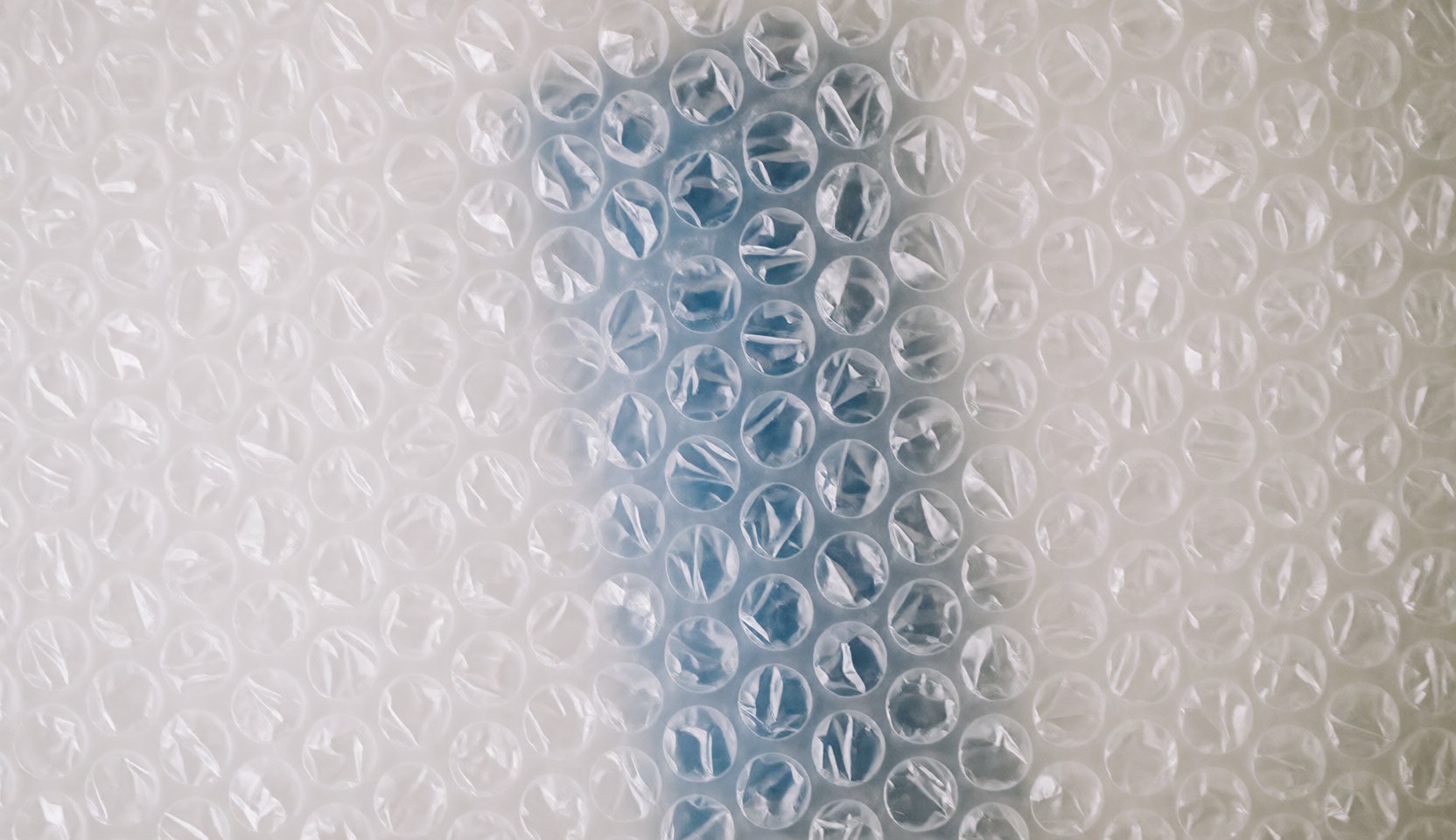 A soft, out-of-focus background featuring light blue and white bubbles, ideal for packaging and moving company text overlays.