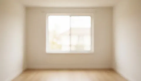A clean, neutral beige interior wall with soft natural light, providing a blank space ideal for adding text or design elements.