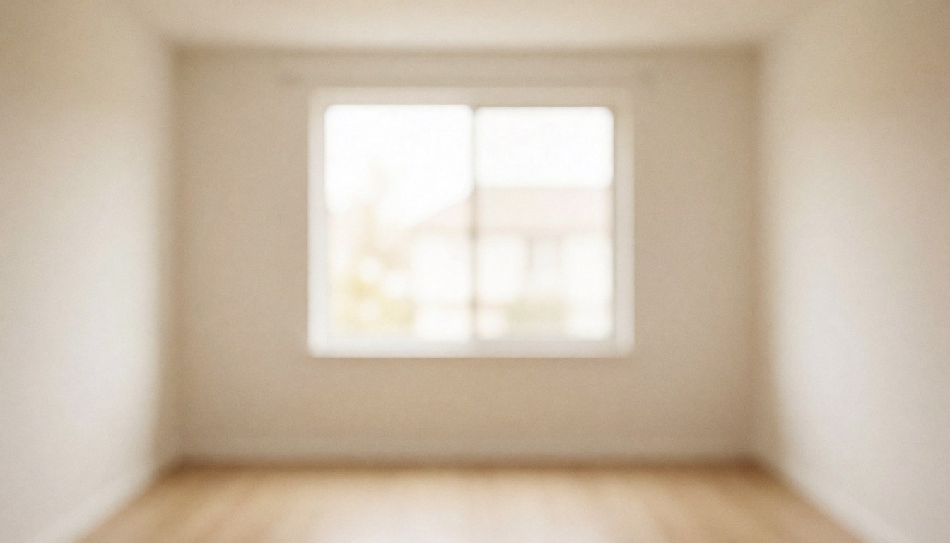 A clean, neutral beige interior wall with soft natural light, providing a blank space ideal for adding text or design elements.
