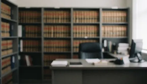 A professional legal library featuring rows of law books on shelves and a clean desk, serving as a background for text.