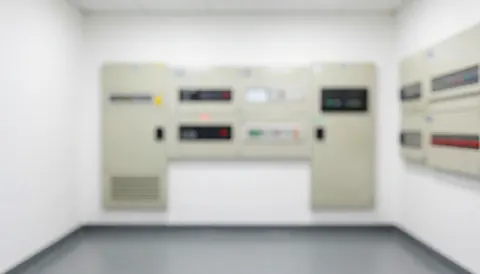 A clean and professional background featuring electrical panels and wiring, suitable for business text overlays with uniform lighting and a tidy industrial aesthetic.