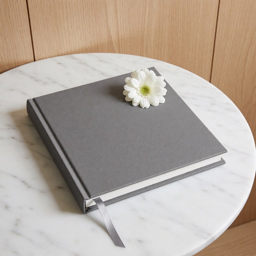 A sleek, elegant closed album resting on a smooth marble surface, showcasing minimalist design and refined texture for professional product photography.