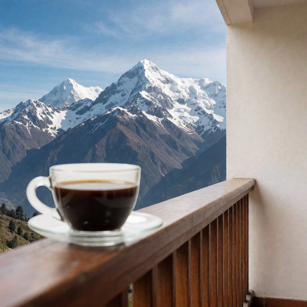 A coffee cup sits on a wooden terrace overlooking snow-capped mountains and a blue sky, suitable for a university campus setting.