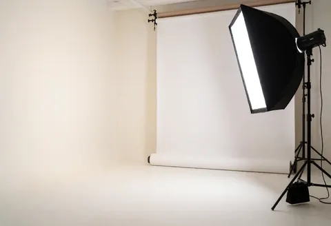 A clean, empty white photography studio with diffused lighting, ideal for commercial product photography and online store visuals