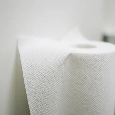 Detailed close-up view of a white paper towel showing its textured surface, suitable for clinical or physical therapy settings