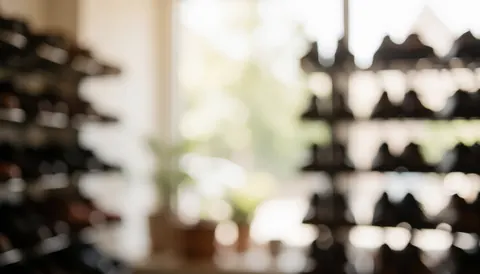 A blurred background of shoes hanging on racks in a shoe store, suitable for text overlay
