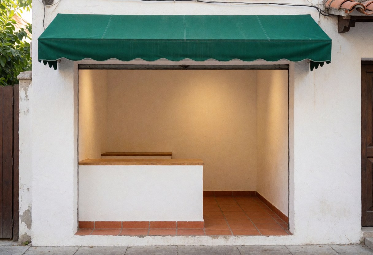 Storefront featuring a green awning, white walls, and terracotta tile flooring under warm lighting for a cozy atmosphere
