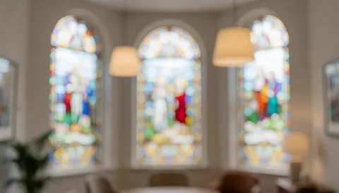 Artistic background featuring colorful stained glass panels with soft bokeh lighting effects suitable for text overlay in interior design contexts