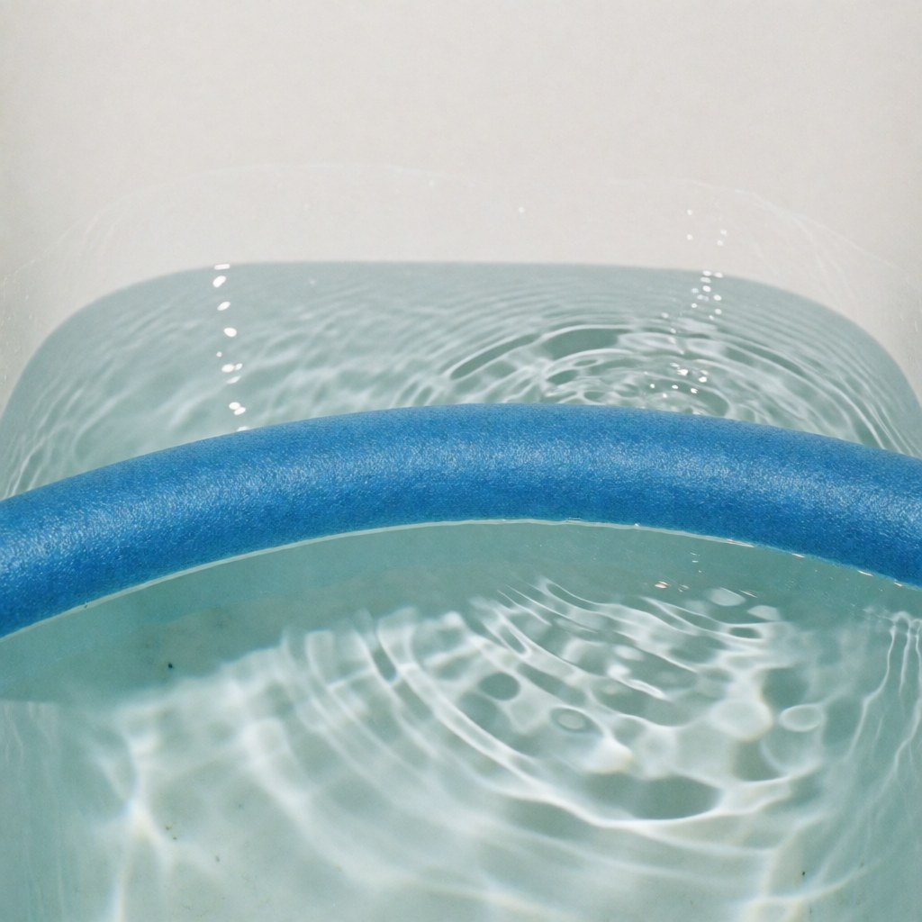 A blue foam noodle floats on the surface of clear, rippling water, suitable for aquatic therapy and advanced physiotherapy treatments.
