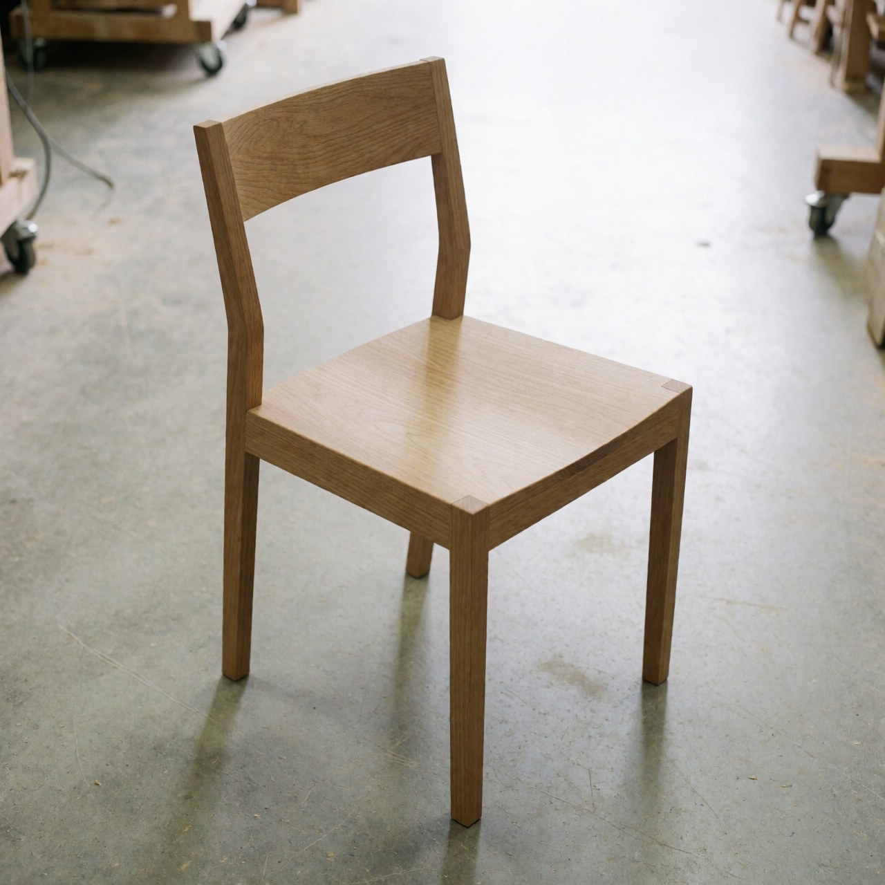 A restored Shaker style wooden chair with clean lines and natural wood finish, suitable for dining or office use.