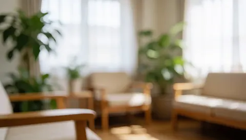 Soft blurred background featuring warm natural light, wooden furniture, plants, and neutral tones ideal for wellness and relaxation themes