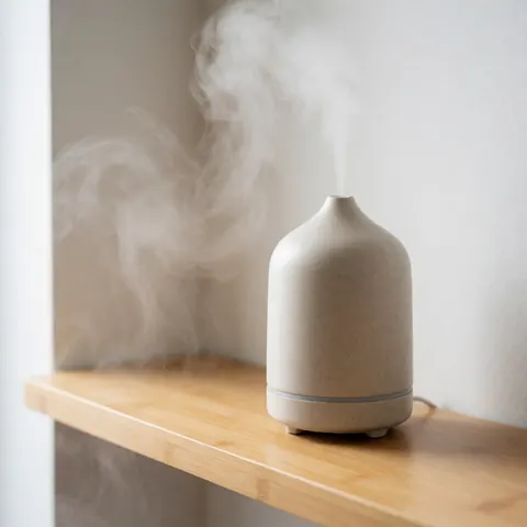A minimalist wooden aroma diffuser releasing a gentle stream of vapor against a white wall, creating a serene and calming atmosphere for wellness spaces.