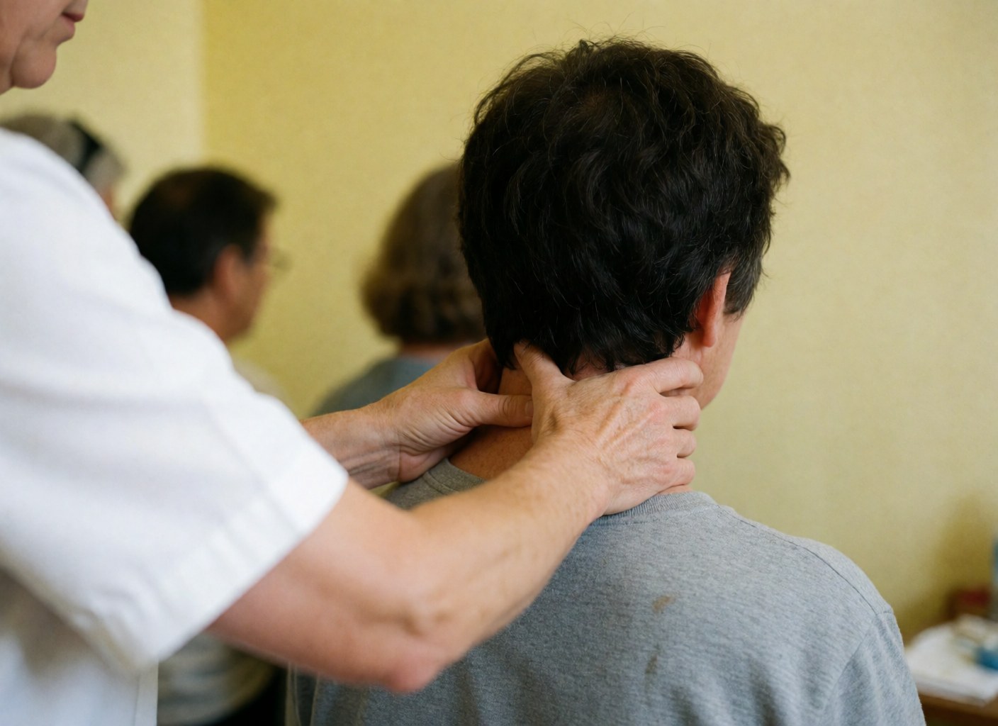 Close-up view of skilled hands applying pressure to a client's neck and shoulders during a therapeutic massage session