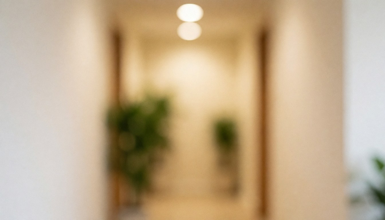 Softly blurred background featuring beige walls, green plants, and warm lighting suitable for spa and wellness text overlays