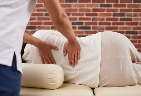 A therapist performs a relaxing back massage on a client in a professional spa setting, focusing on muscle relief and wellness.
