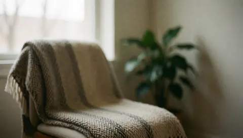 Close-up of a woven textile background with neutral tones, suitable for text overlay in wellness and therapy contexts