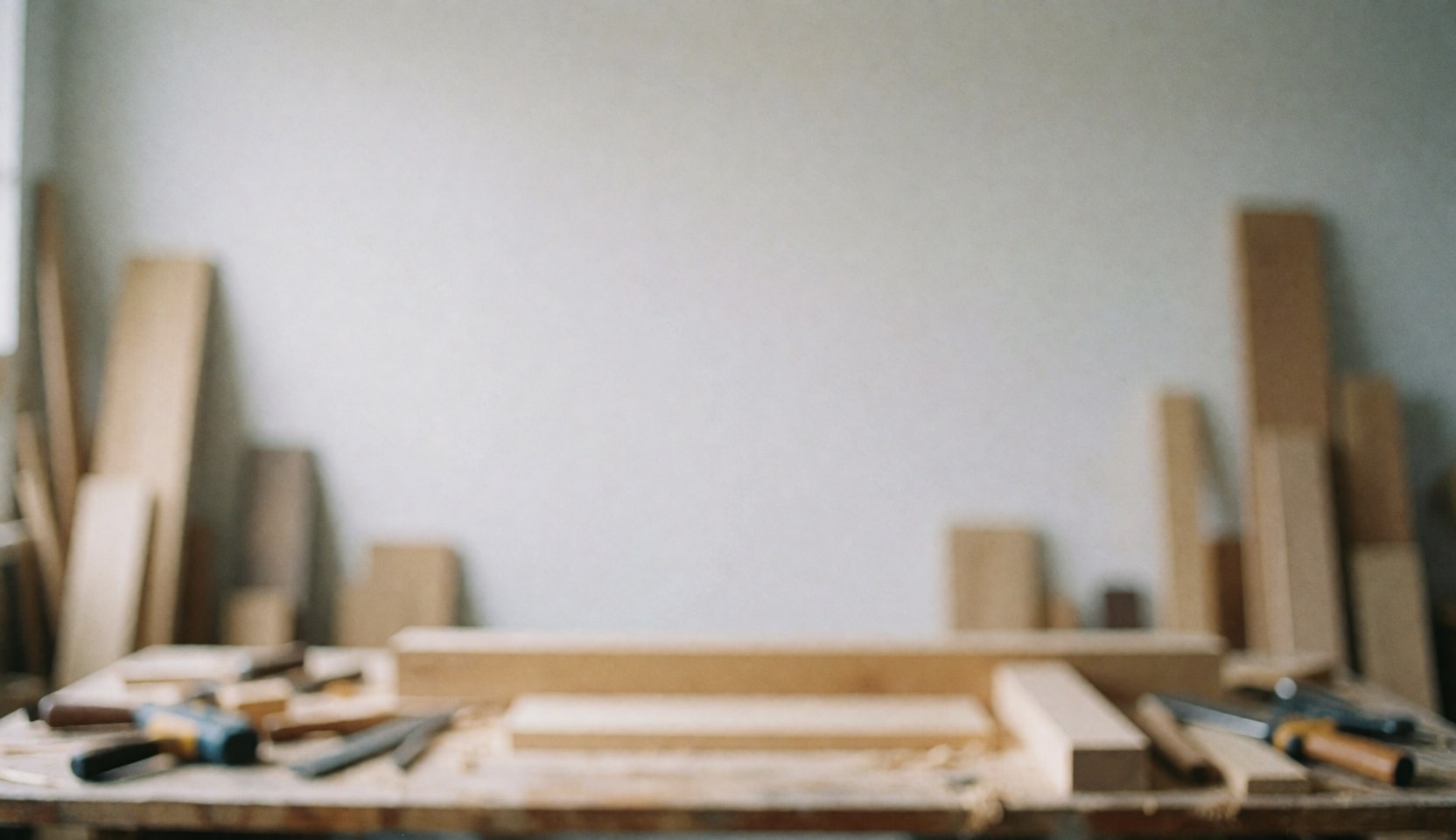 Blurred background of a carpentry workshop with wooden panels and tools, ideal for text or custom furniture designs