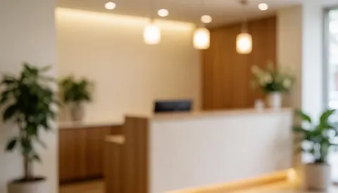 Interior of a clinic reception area featuring green plants and warm lights, suitable for holistic health and wellness service backgrounds