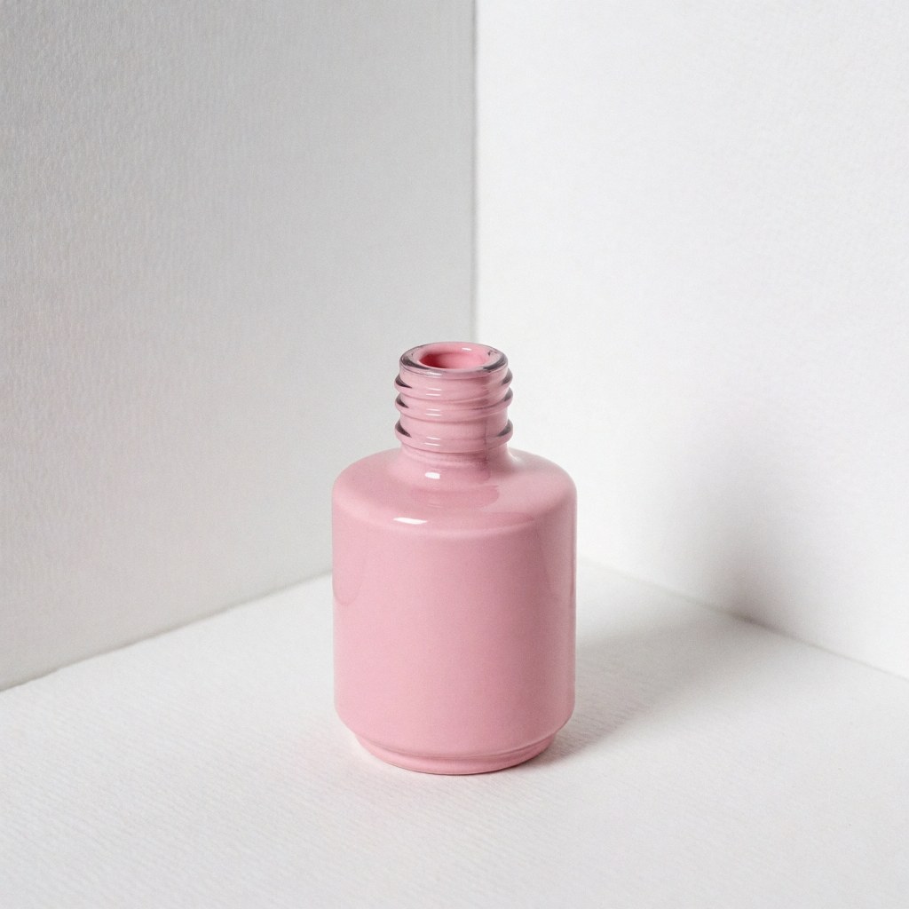 Open pink nail polish bottle placed on a white surface with soft lighting and a clean white background for beauty salon product display