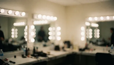 Soft focus background of an event dressing room featuring vanity mirrors, circular lights, and makeup tables, ideal for event photography text overlays