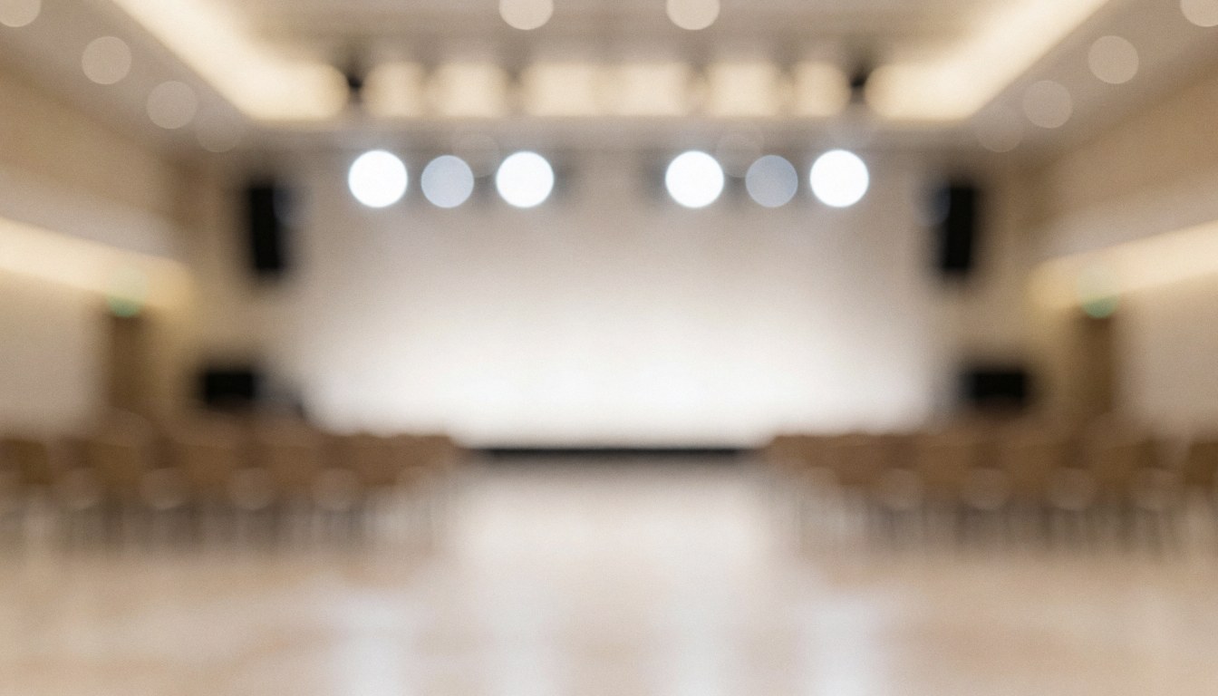 Warm blurred event background with stage lights and empty seats, ideal for text overlay, professional and calm atmosphere