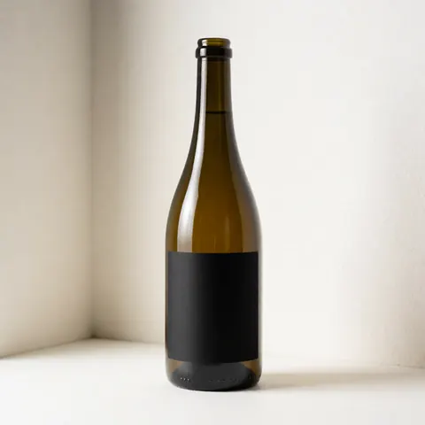 Glass jar with black label in white corner, softly lit, ideal for showcasing label design for textile printing services