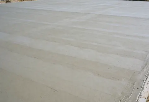 Smooth gray concrete base prepared for a tennis court, ideal for business advertising and promotional text overlays.