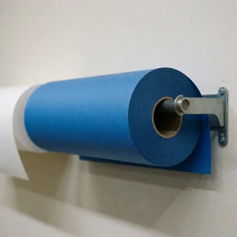 Blue and white seamless paper rolls mounted on a wall stand under neutral lighting for studio product photography