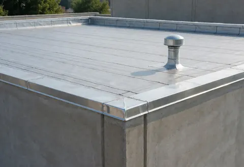 Flat industrial roof featuring a metal ventilation unit, stainless steel edging, and concrete walls suitable for commercial roofing repair services