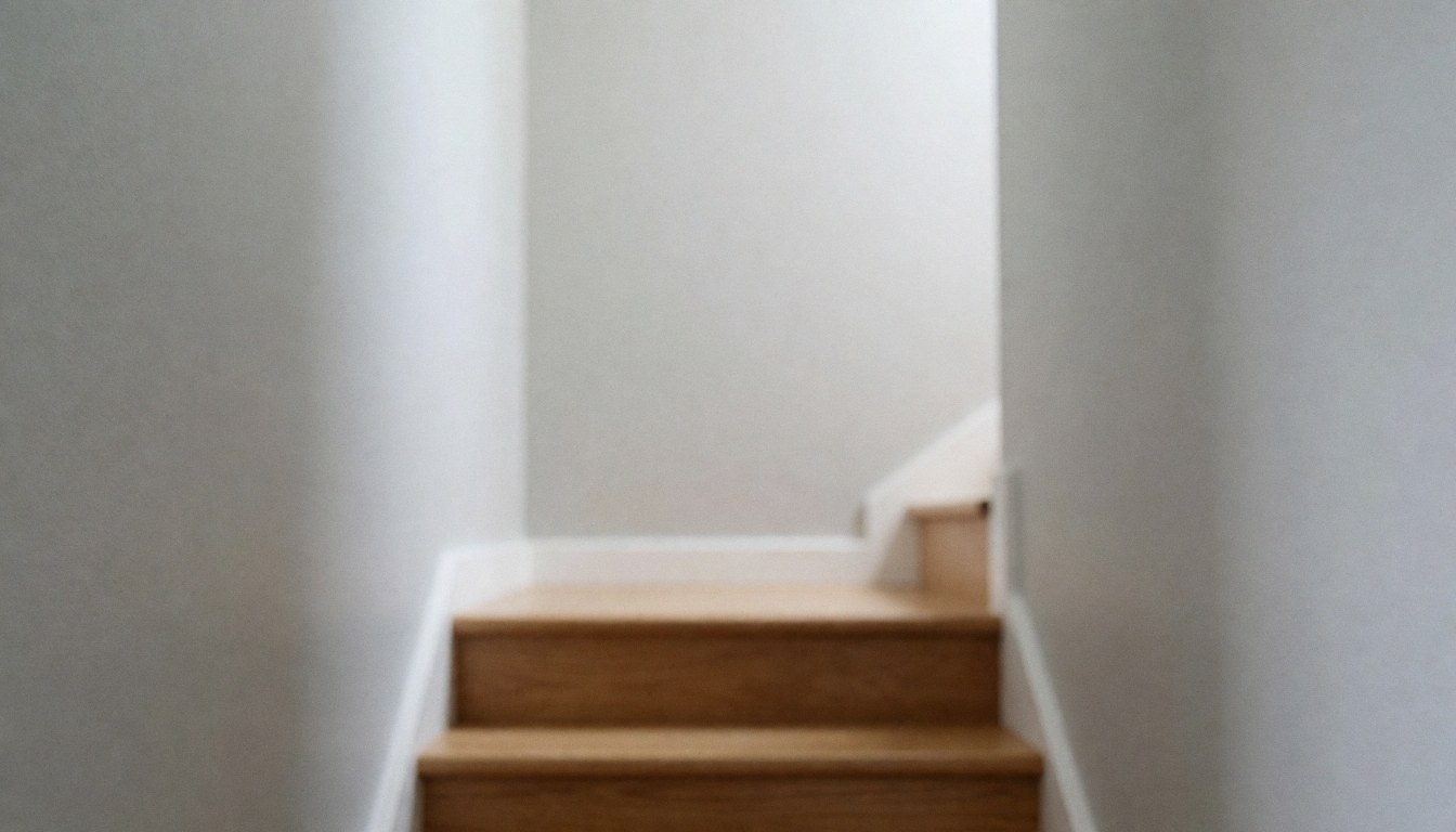 Wooden stairs against gray walls, soft background for text, ideal for house painting ads