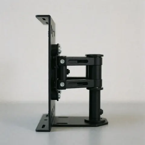 Black universal tv mounting bracket with adjustable arms and visible screws on a gray surface