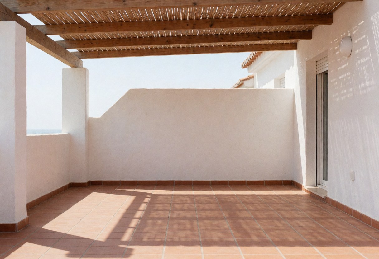 Residential patio featuring a wooden awning with geometric shadows on terracotta tile floor and stucco walls, showcasing awning installation.