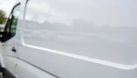 White van with soft metallic texture, ideal for placing text over a work vehicle for roof repair services.