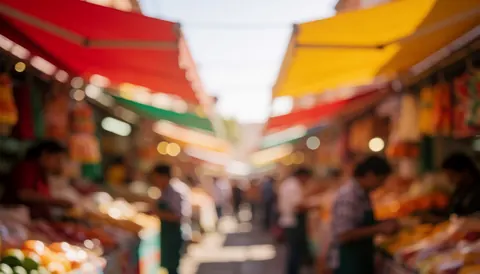 Blurred background of red and yellow awnings with warm lights and bokeh effect, suitable for commercial text overlay