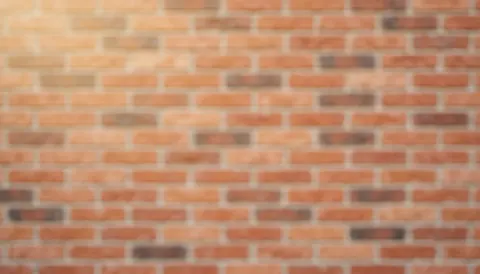 Empty warm terracotta brick wall texture serving as a clean background for house painting promotions and text overlays