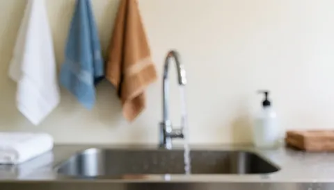 Clean bathroom background with hanging towels, ideal for text overlay, professional and calm atmosphere