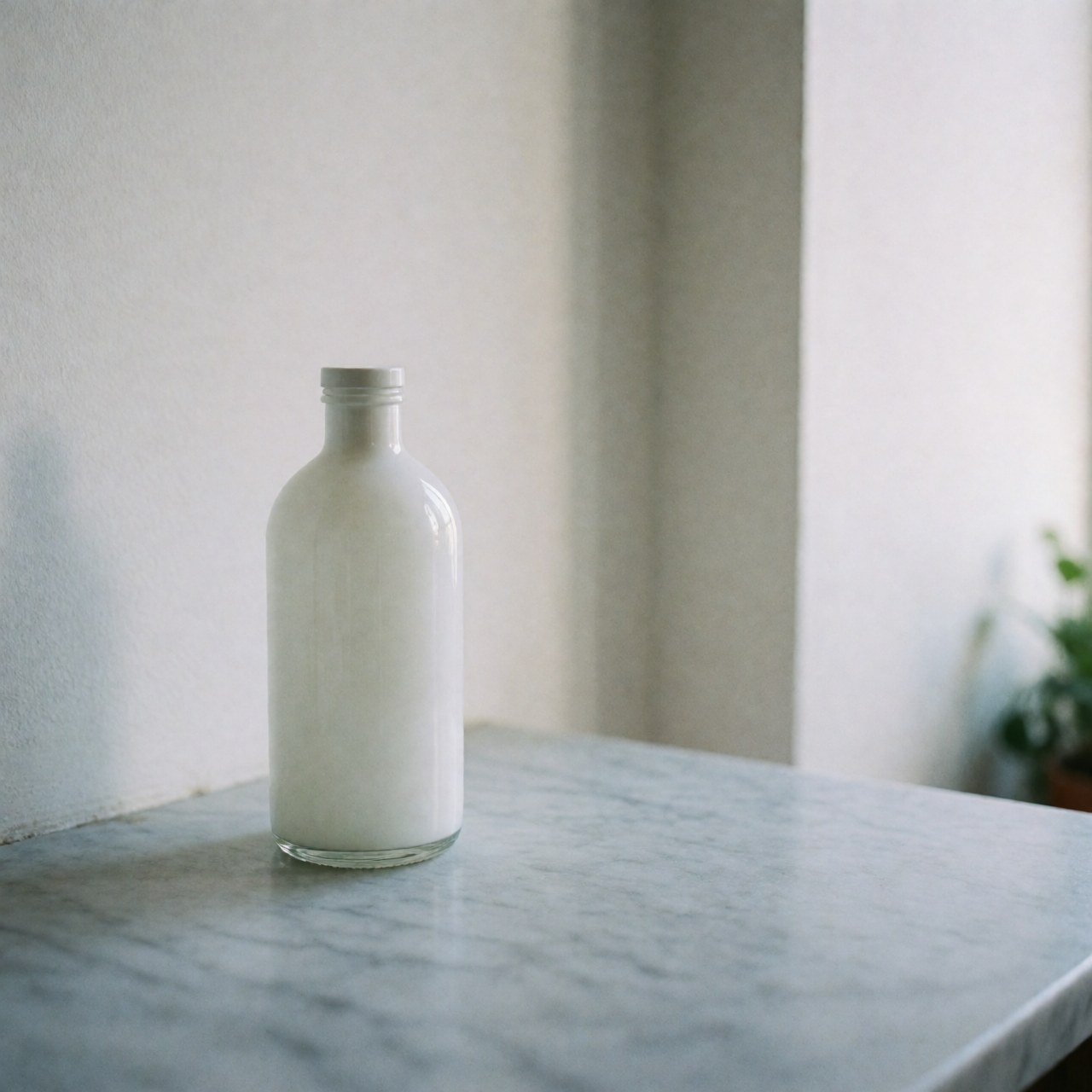 White glass jar with lid on light gray marble table, white wall, soft natural light, no people, ideal for skincare products