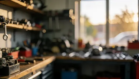 Shelves of motorcycle repair tools illuminated by warm sunset light, creating a professional background for service text overlays