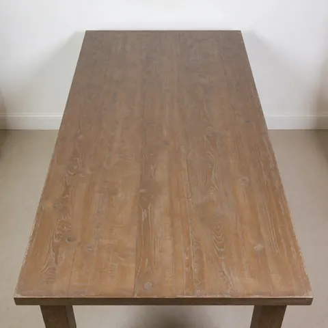 Dining table with matte finish and worn edges on white background, ideal for antique furniture restoration