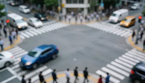 Blurry city background featuring vehicles and pedestrians at an intersection, suitable for last-mile delivery logistics text overlays in gray and blue tones