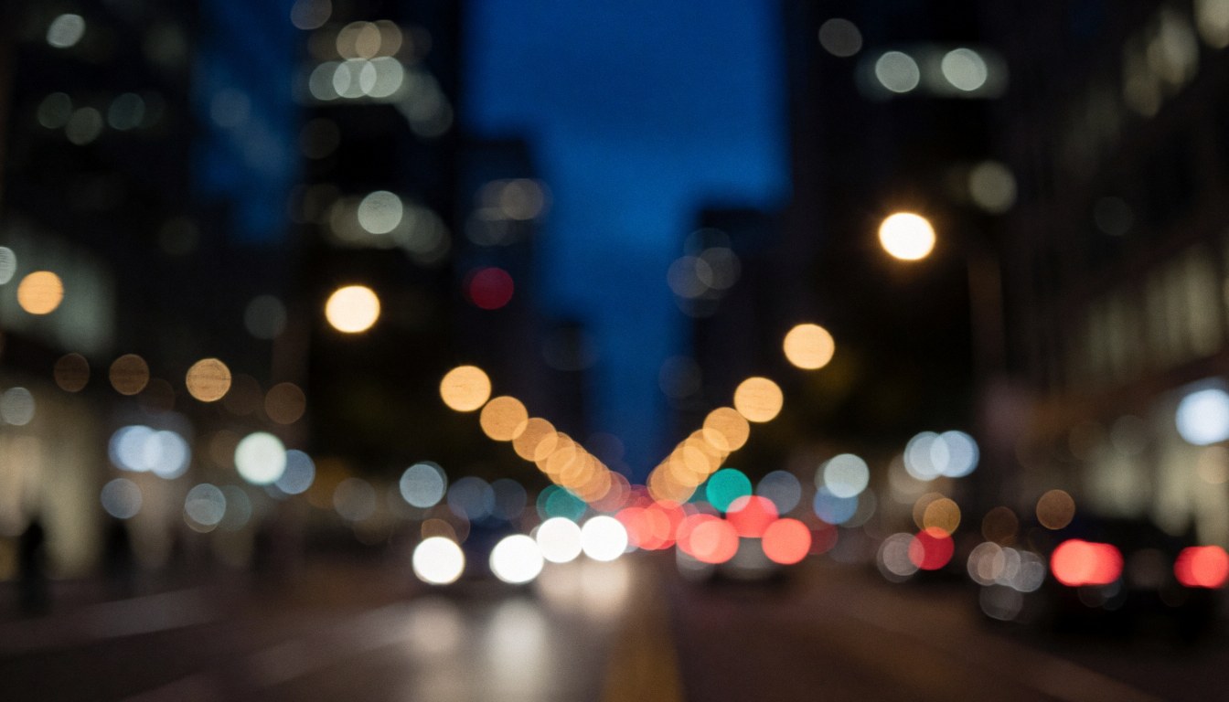 Blurred night city background with blue and black tones from car and building lights, suitable for transport service text overlays