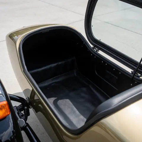 Empty black seat motorcycle taxi sidecar box with open door on concrete ready for transport