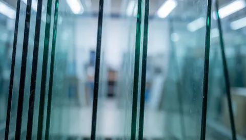 Professional background of stored glass with vertical lines, cool blue light and shallow depth of field, ideal for commercial text.