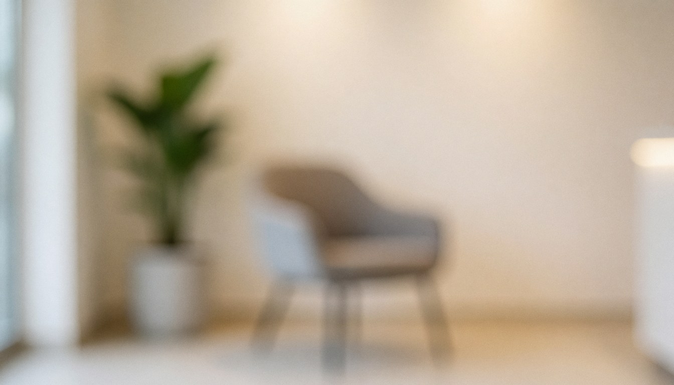 Modern reception area with a chair and plant in bokeh, creating a calm and professional atmosphere for text overlay.