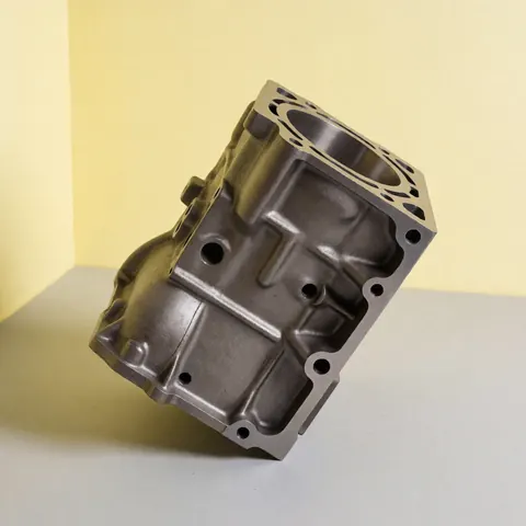 Polished cast iron engine block on a gray background with yellow walls for an industrial welding shop