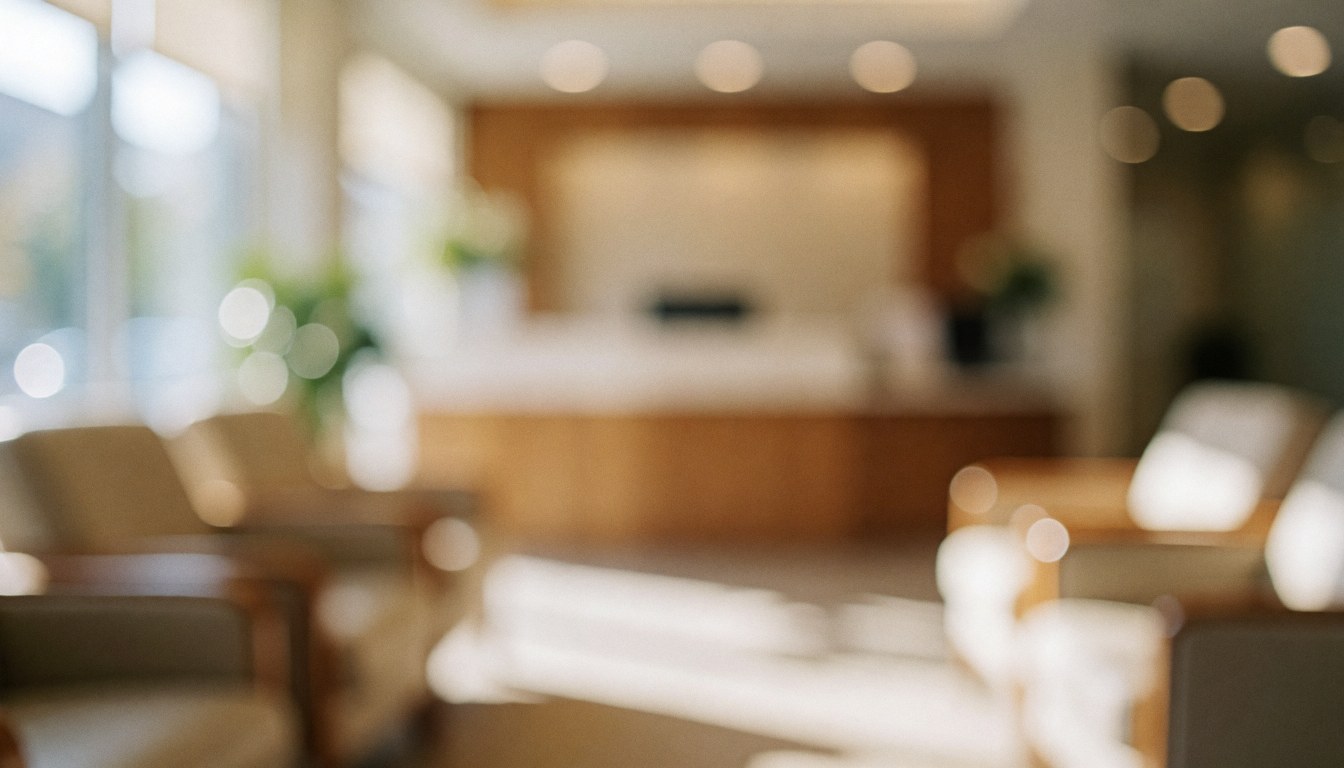 Soft focus background of a modern waiting area featuring comfortable chairs and a wooden reception desk, suitable for professional text overlays.