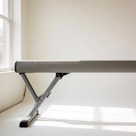 Portable gymnastics apparatus with metal frame in a studio with white walls and natural light, ideal for gymnastics professionals.