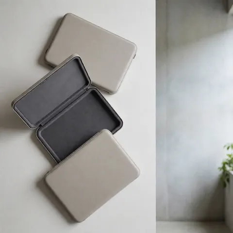 Three neutral laptop cases with padded interiors displayed on a clean white surface for computer repair business use