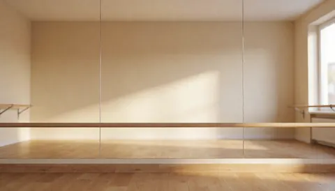 Empty dance studio featuring beige walls, a wooden ballet barre, and parquet flooring, providing a clean background for text overlays.
